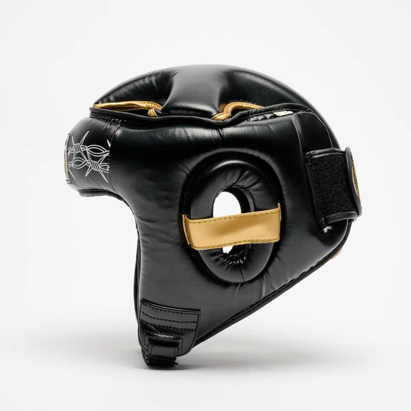 Profilo del casco LEONE x IUTER che mostra la protezione auricolare imbottita e le rifiniture oro
