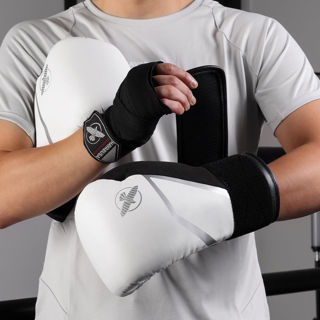 Sportler trägt weiße Hayabusa E1 Boxhandschuhe in Schutzposition