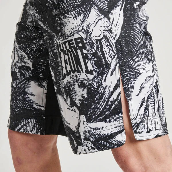 Close-up ad alta risoluzione del graphic print "La Divina Combattente" in stile incisione dei pantaloncini LEONE x IUTER, rivelando i volti e l'acconciatura mitologica.