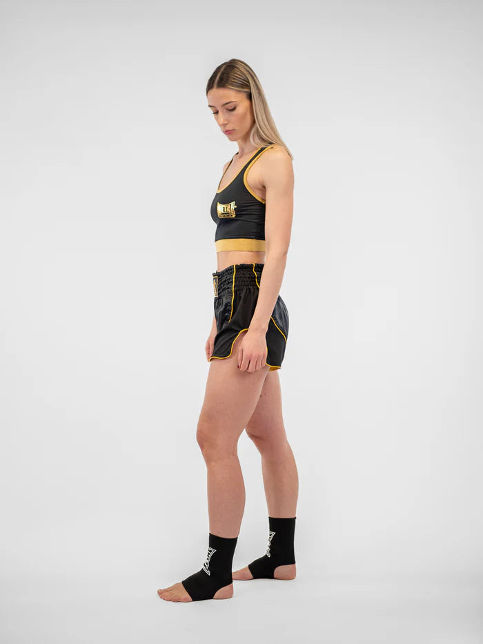 Vista laterale pantaloncini donna Metal Boxe Siam nero oro, dettaglio dello spacco per calci