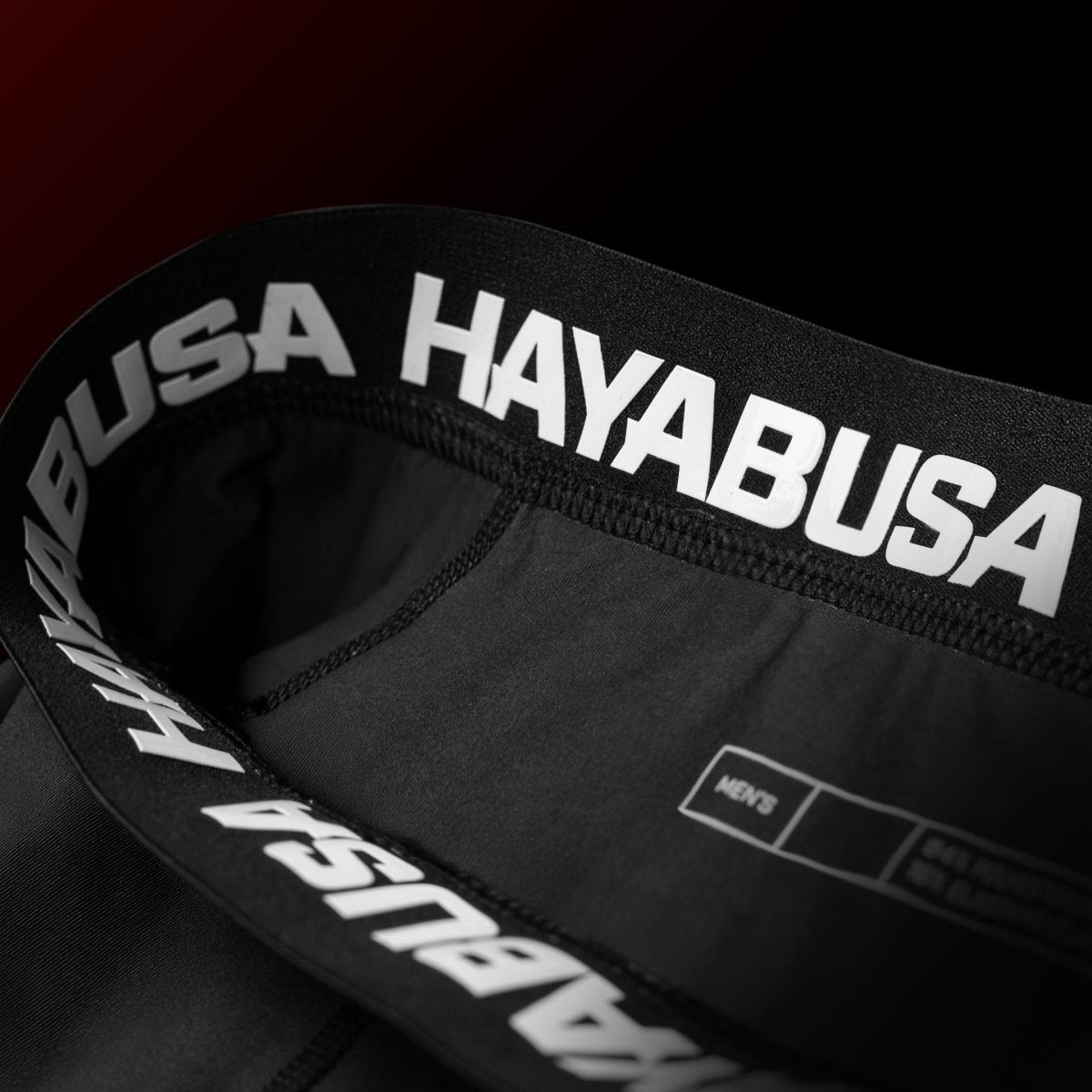 Detalhe do cós de silicone do short oficial de Jiu-Jitsu vermelho e preto do UFC