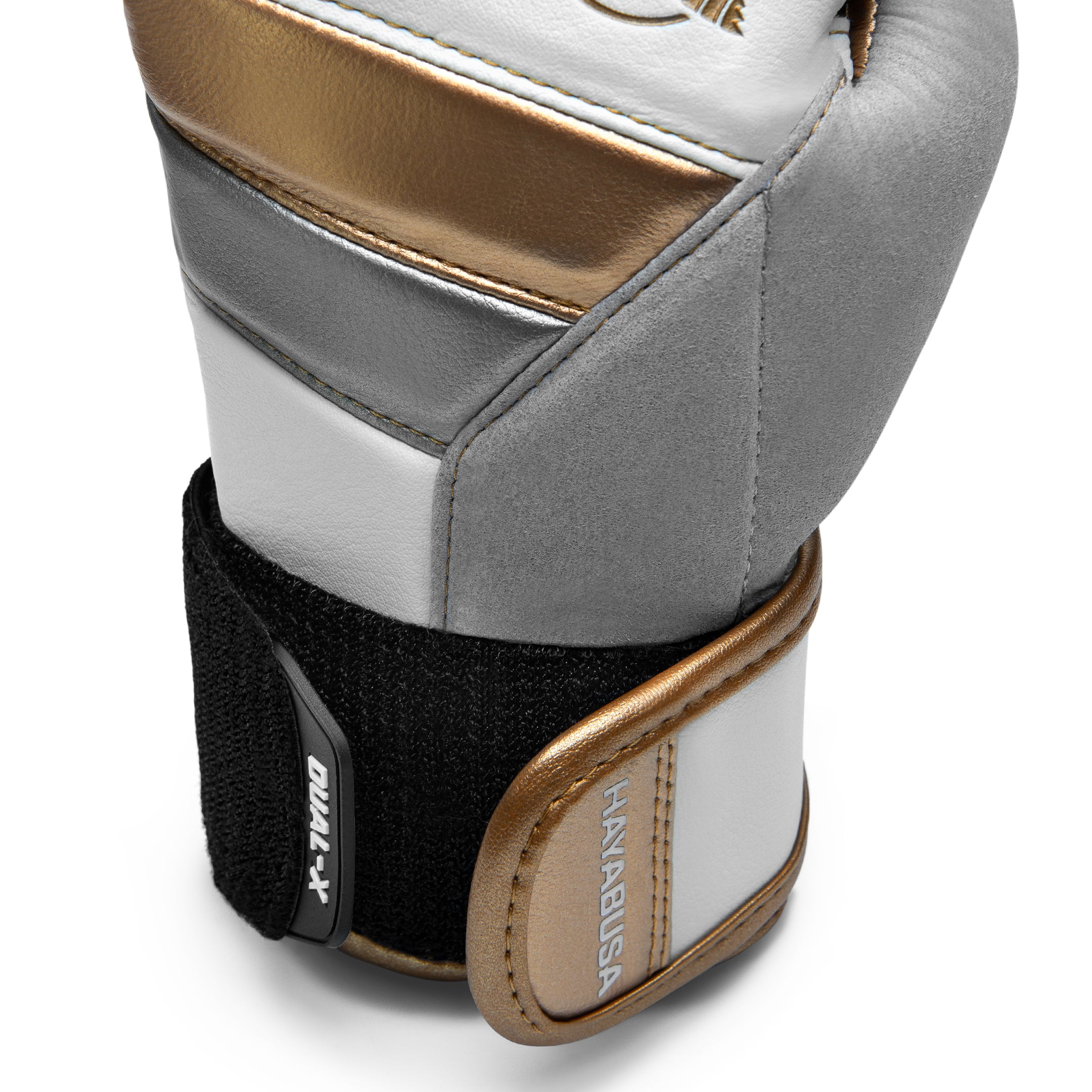 Primo piano della chiusura rinforzata dei guantoni bianco/oro Hayabusa T3