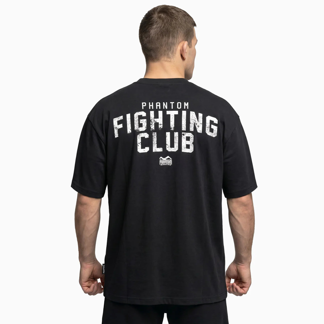 Vista traseira da t-shirt preta oversize Phantom com a grande inscrição gráfica «Fighting Club» nas costas