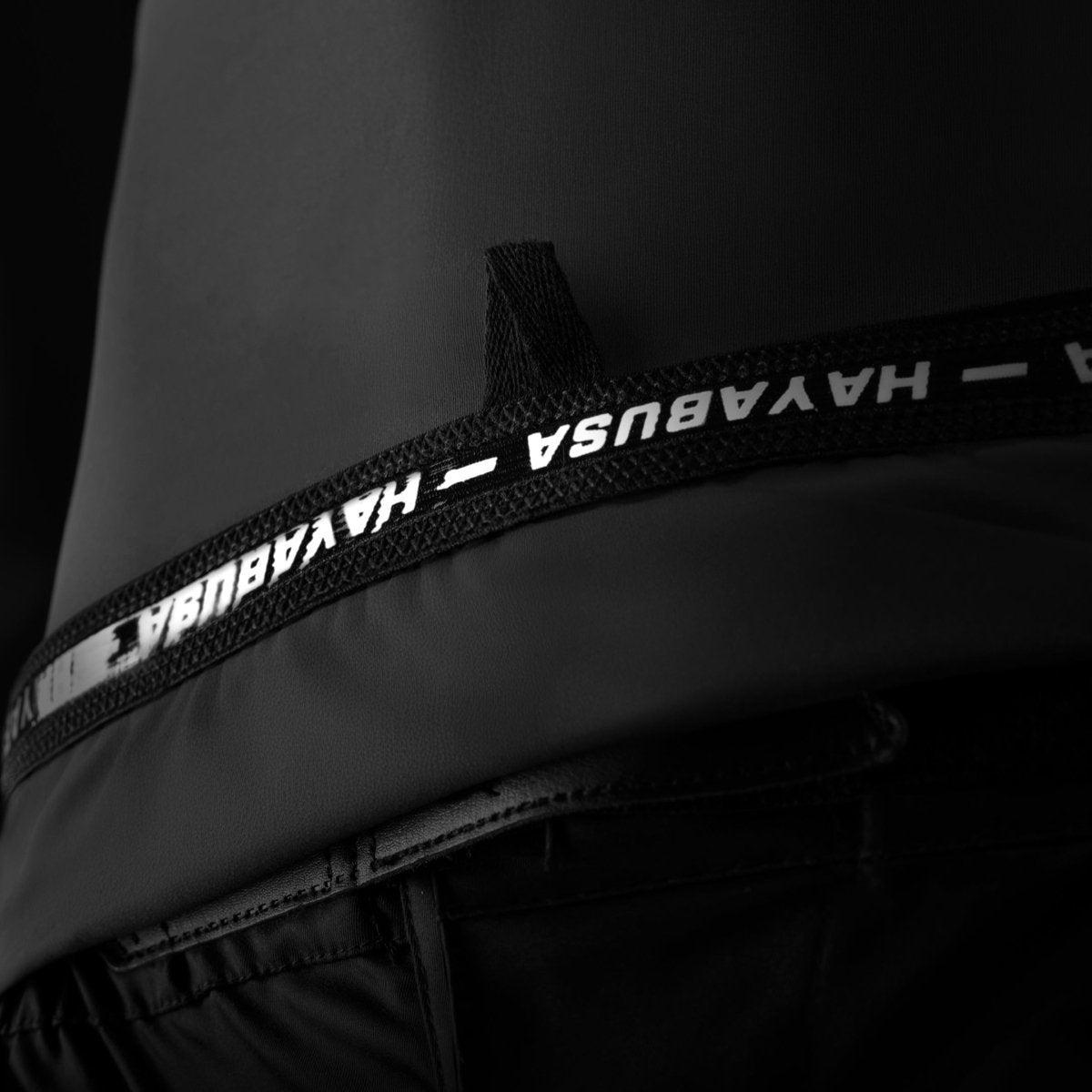 Detail of the technical writing and internal specifications printed on the black Hayabusa rashguard