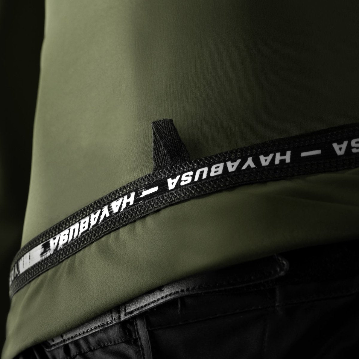 Close-up detail of the internal technical information on the green Hayabusa Core rashguard